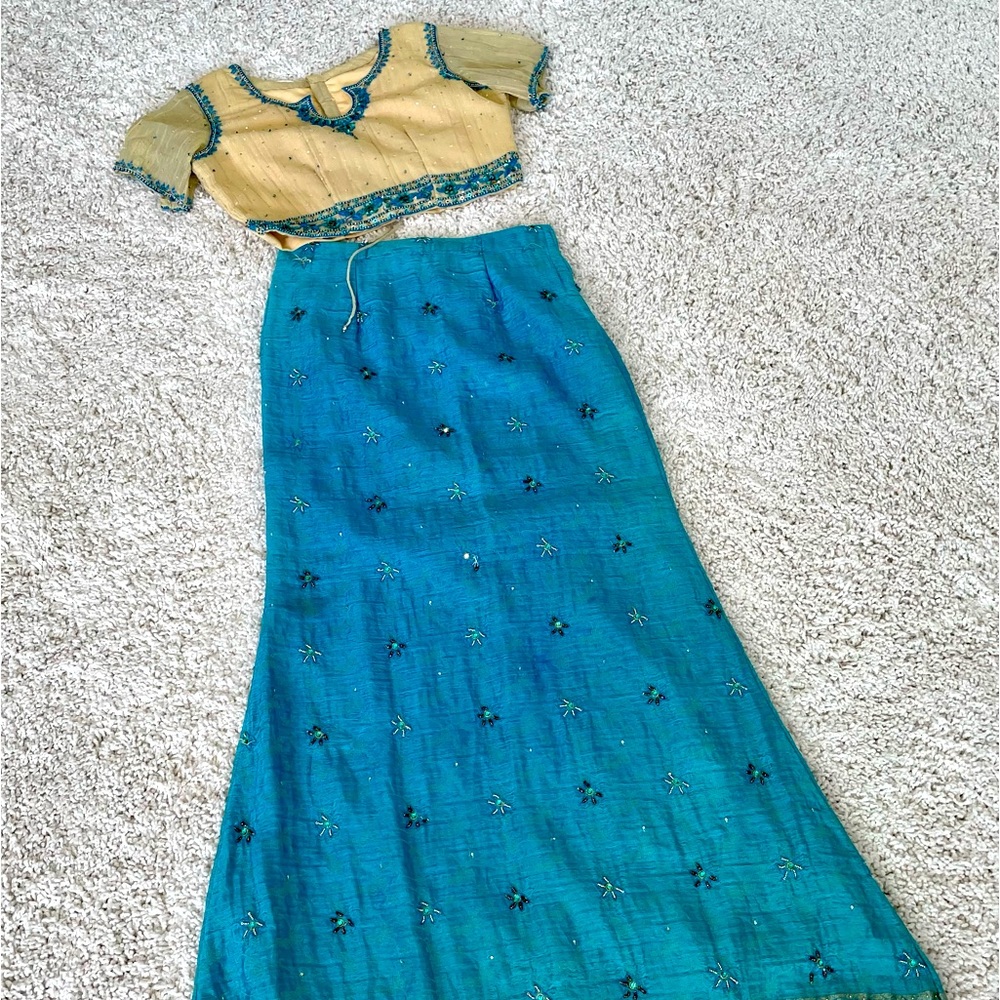 Blue and gold lehenga and blouse. Small stain on the back that can be washed.